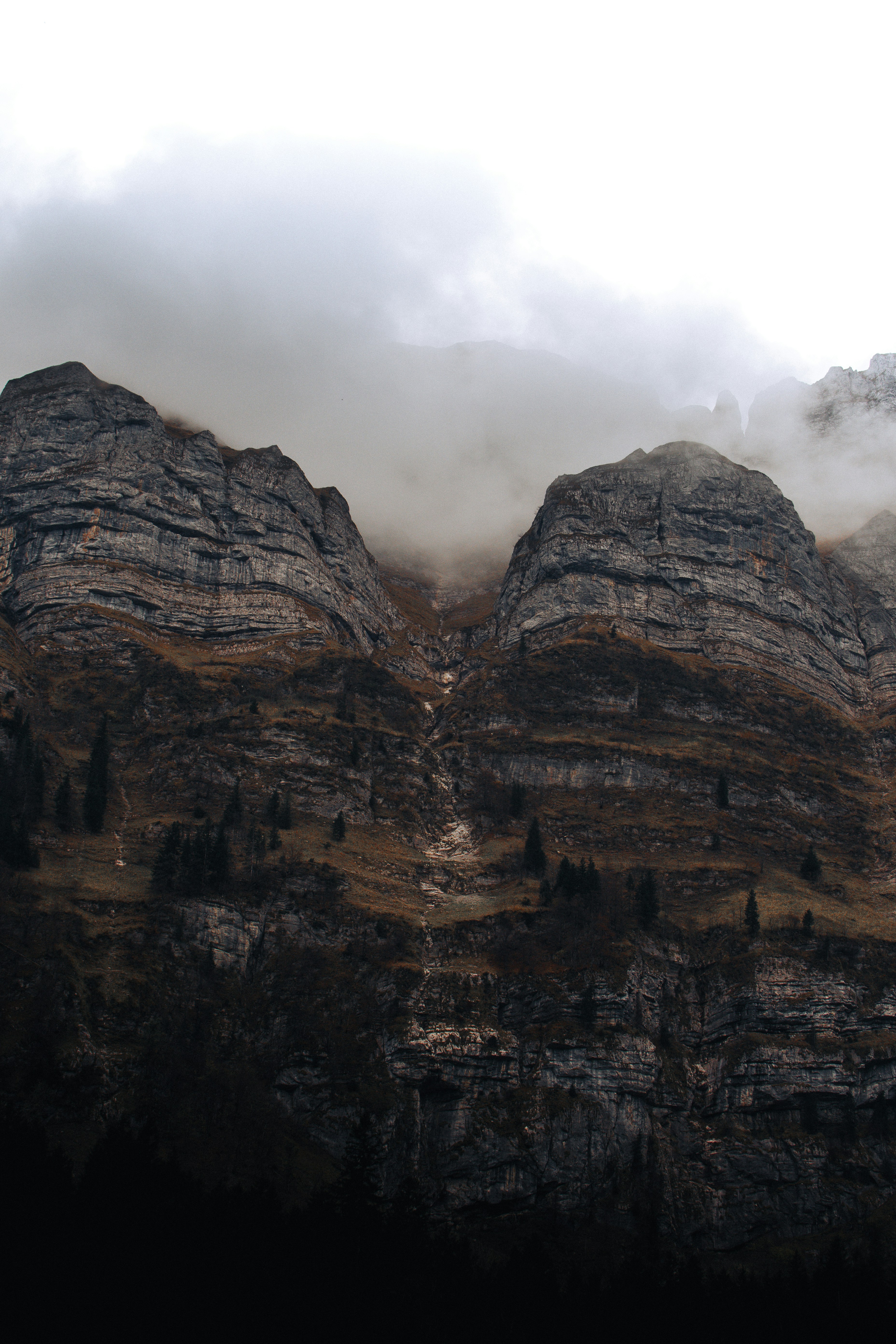 a rocky mountain with clouds