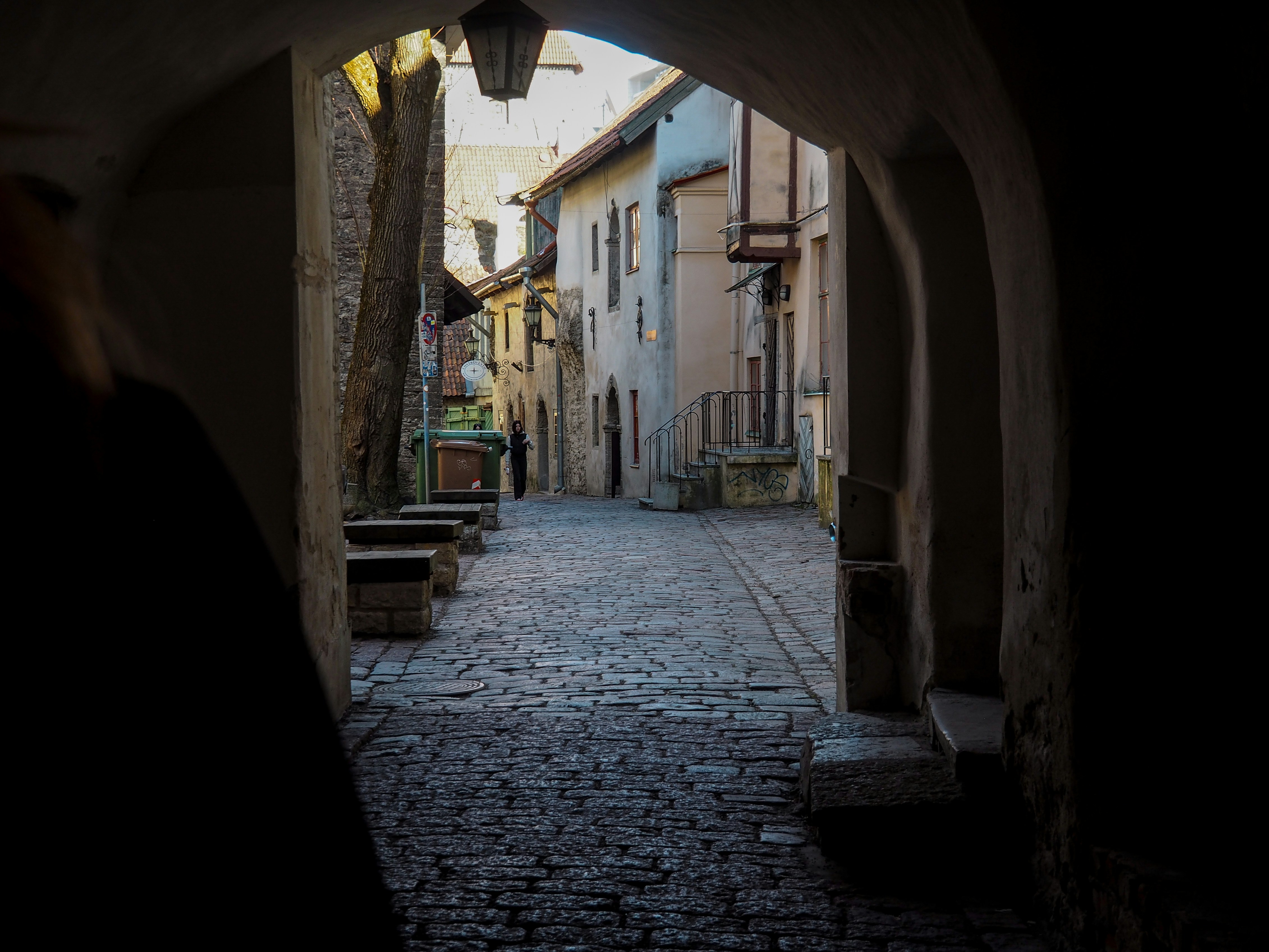 a cobblestone street with buildings on either side of it