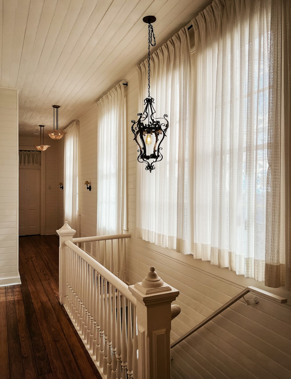 a staircase with a chandelier