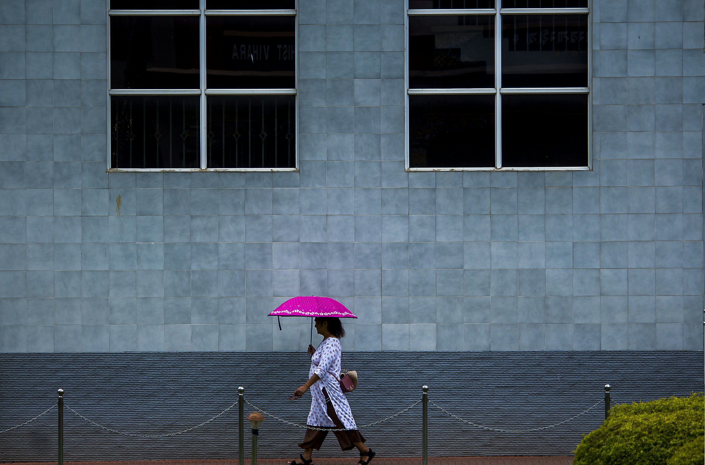 a woman walking with an umbrella