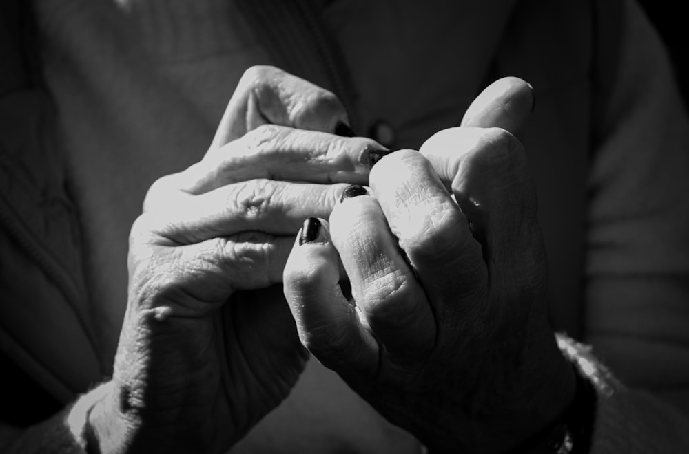 a close-up of hands holding each other