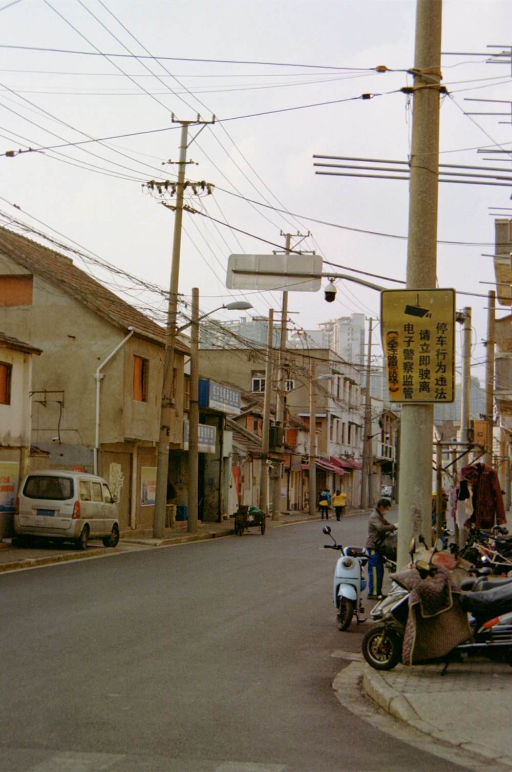 a street with a motorbike and a sign on it