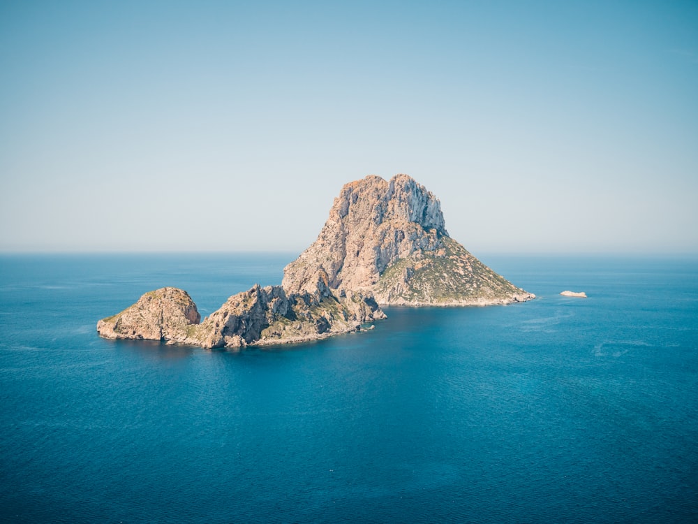 a large rock island in the middle of the ocean