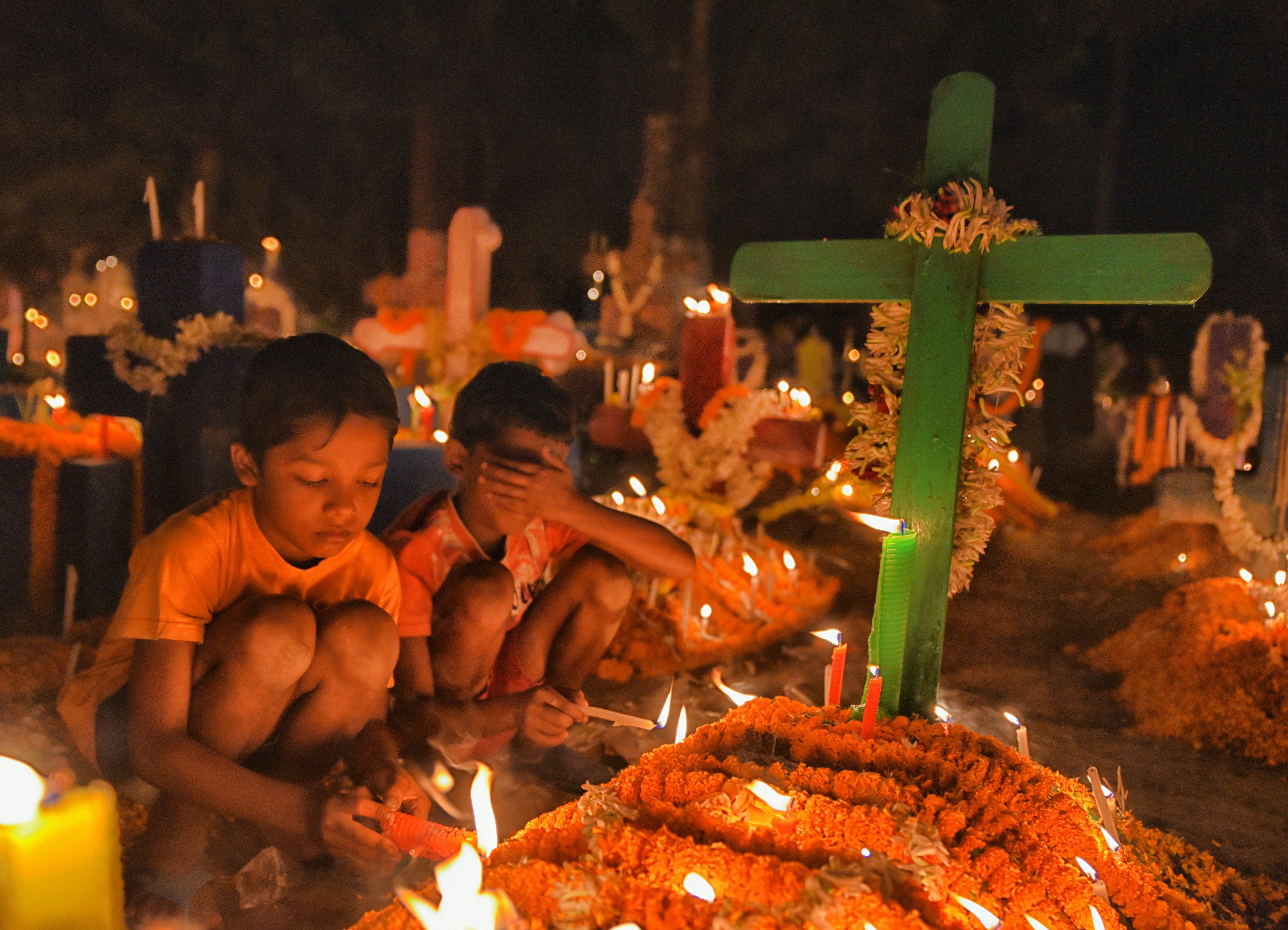 a group of kids sitting around a table with a cake