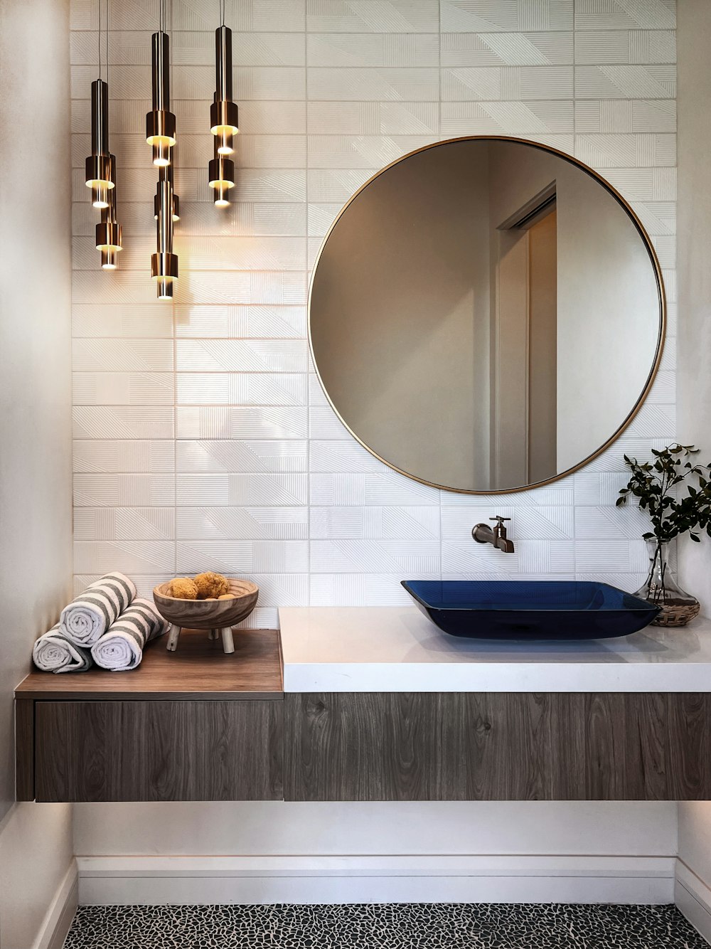 a bathroom with a round mirror