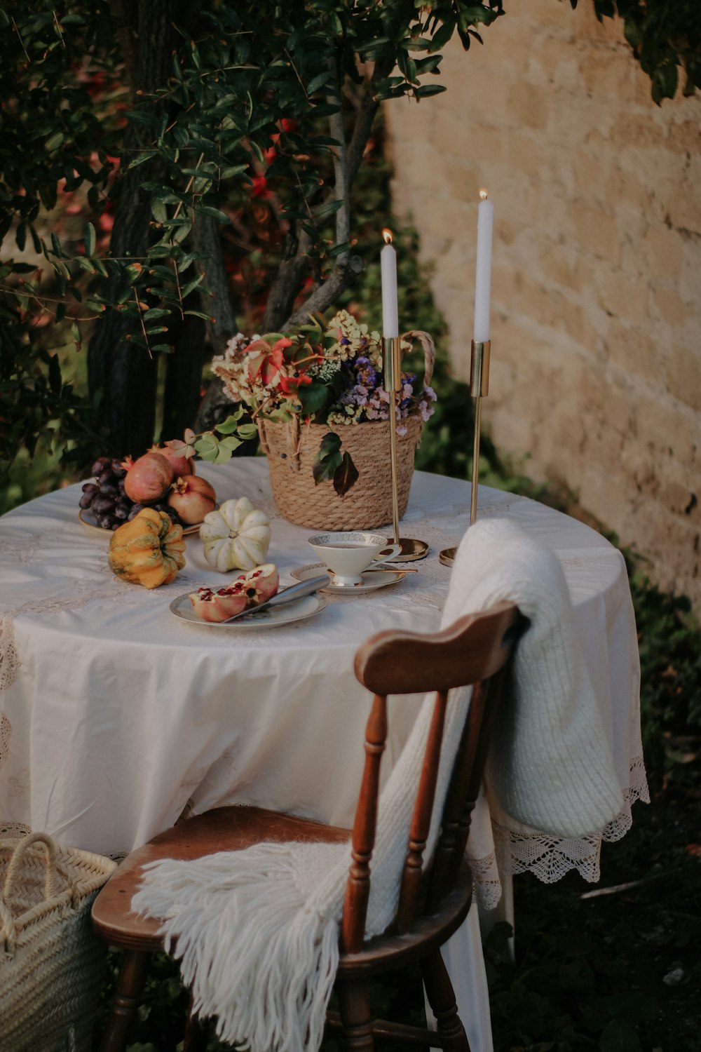 a table with a candle and flowers on it