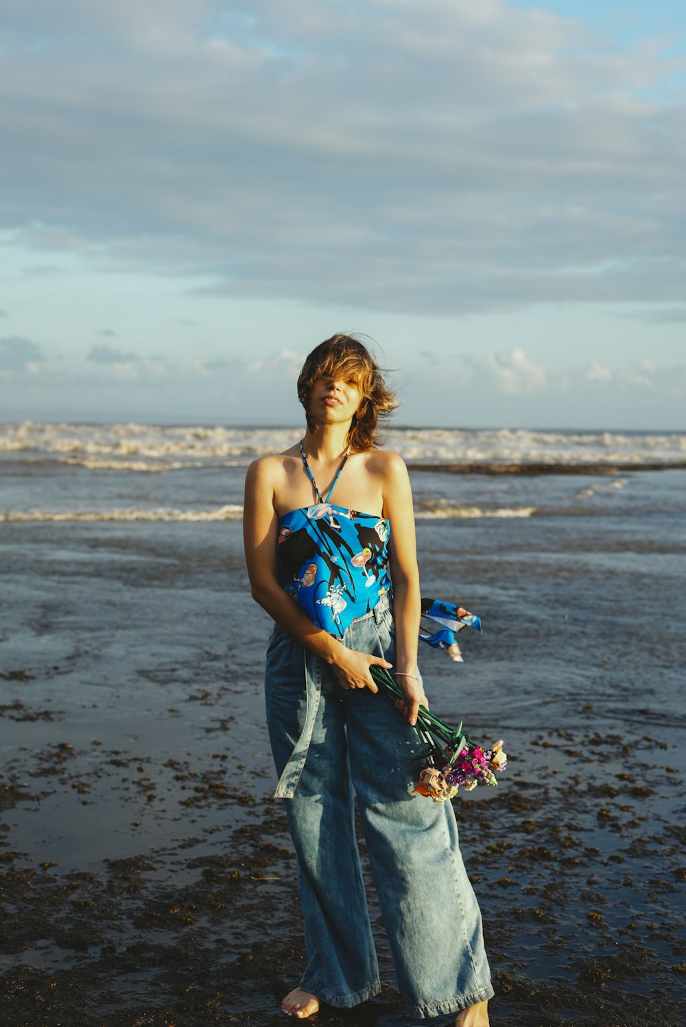 a person in a blue dress on a beach