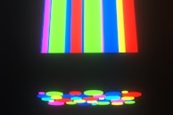 Multi-colored screen printed design with bold lines on a dark shirt.