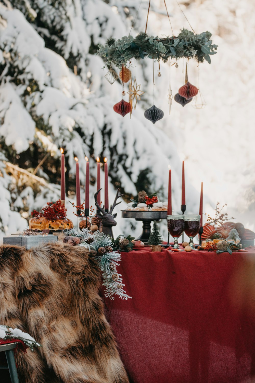 a dog sitting at a table with candles and decorations