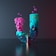 a blue and pink vase with a flower in it