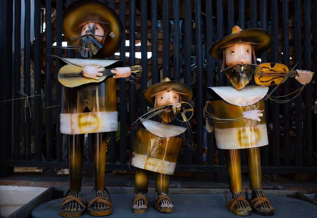 a group of statues of people wearing clothing,