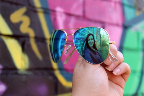 A vibrant photoshoot featuring influencers wearing bold, stylish eyewear frames in an urban setting.