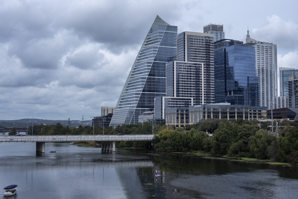 a bridge over a river with a city in the background