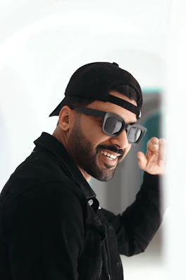 A smiling individual celebrating a financial milestone, with a dark mode styled background.