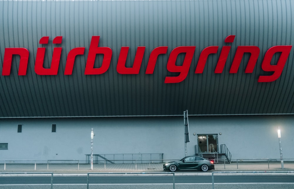 a car parked in front of a large building