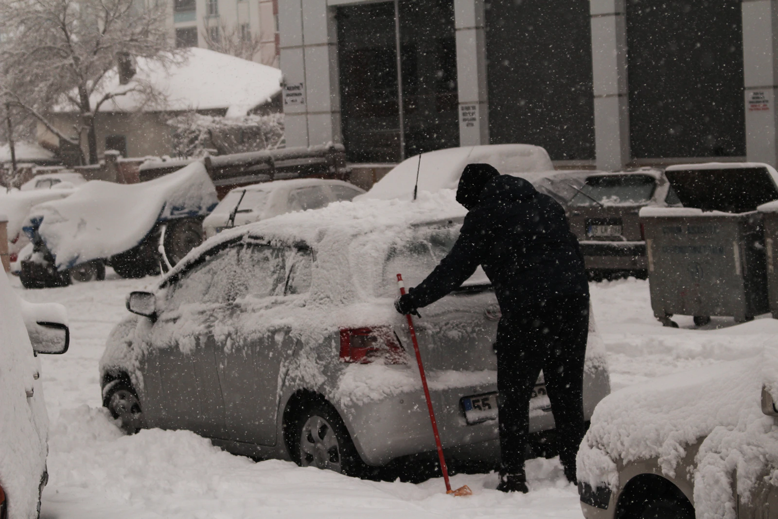 Snow being cleared away by hand after a storm