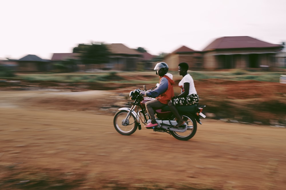 a couple of people riding a bike