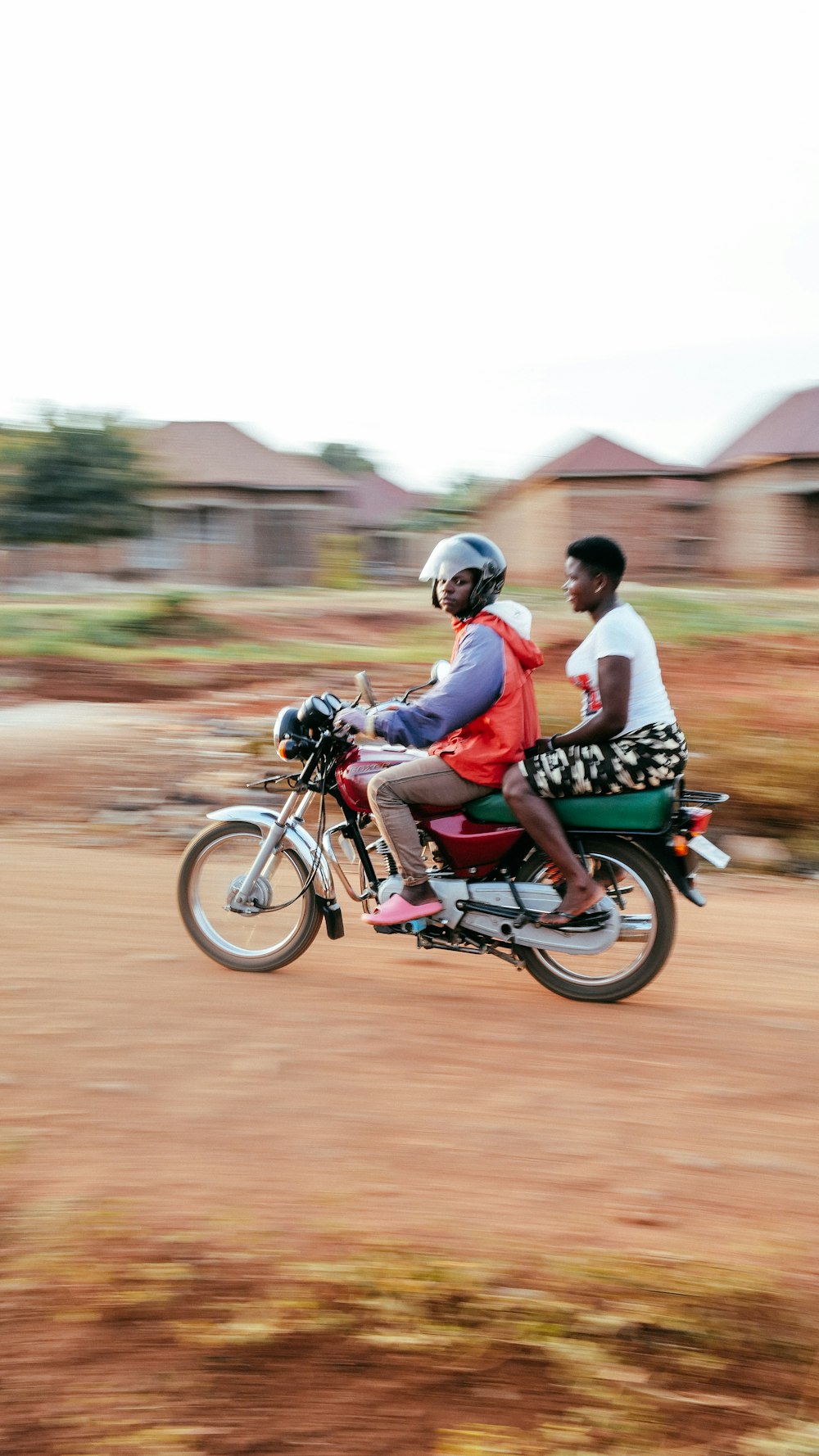 a man and a woman riding a motorcycle