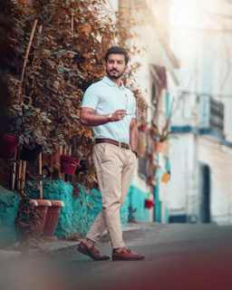 A stylish man in relaxed casual attire walking through Hyderabad’s streets at sunset