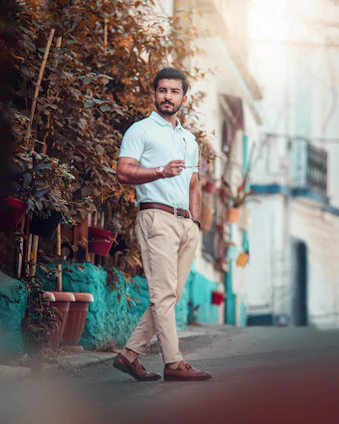 A stylish man in relaxed casual attire walking through Hyderabad’s streets at sunset
