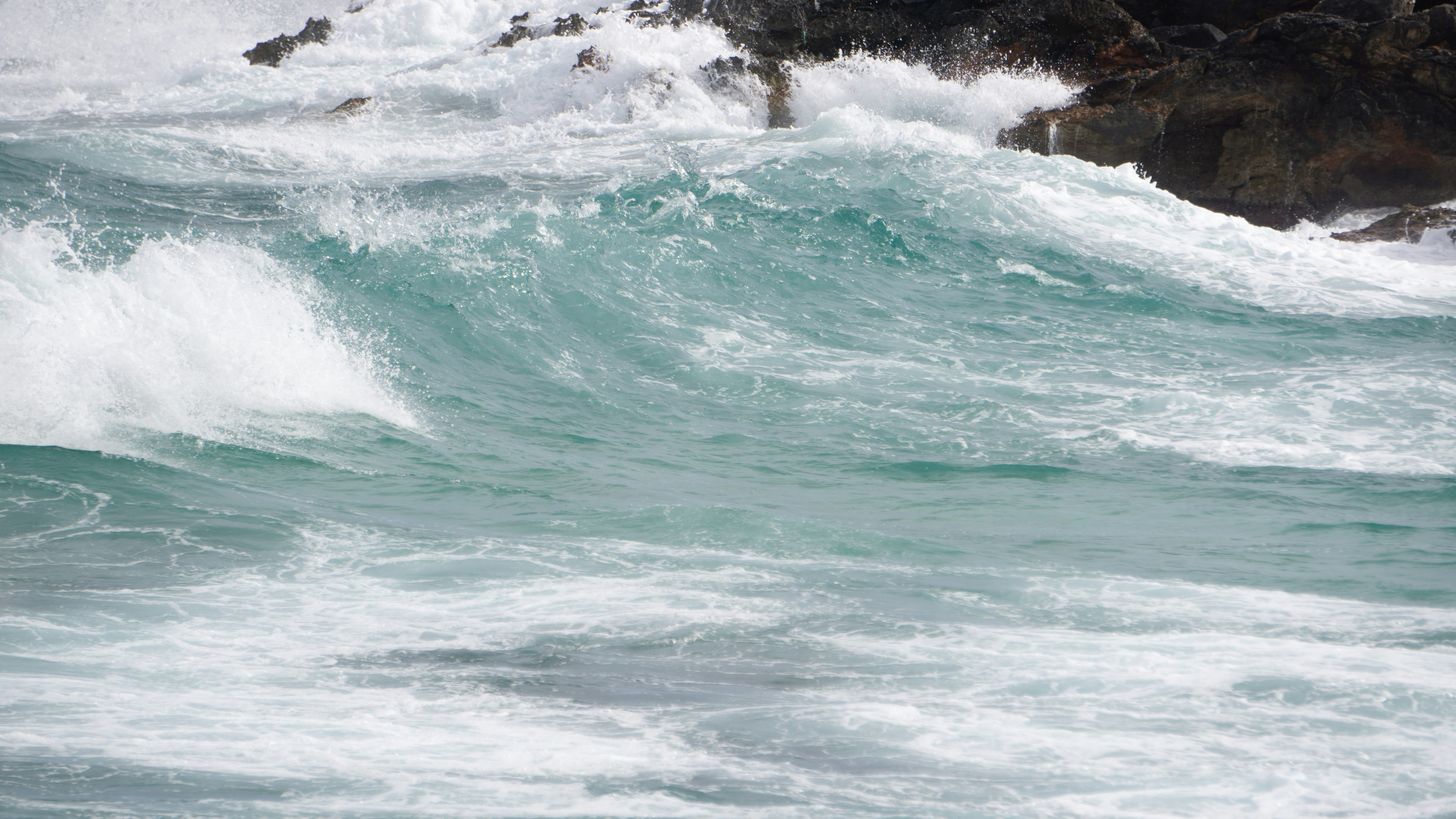 a wave crashing against a rock