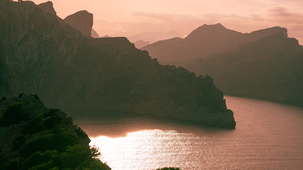 a body of water with mountains around it