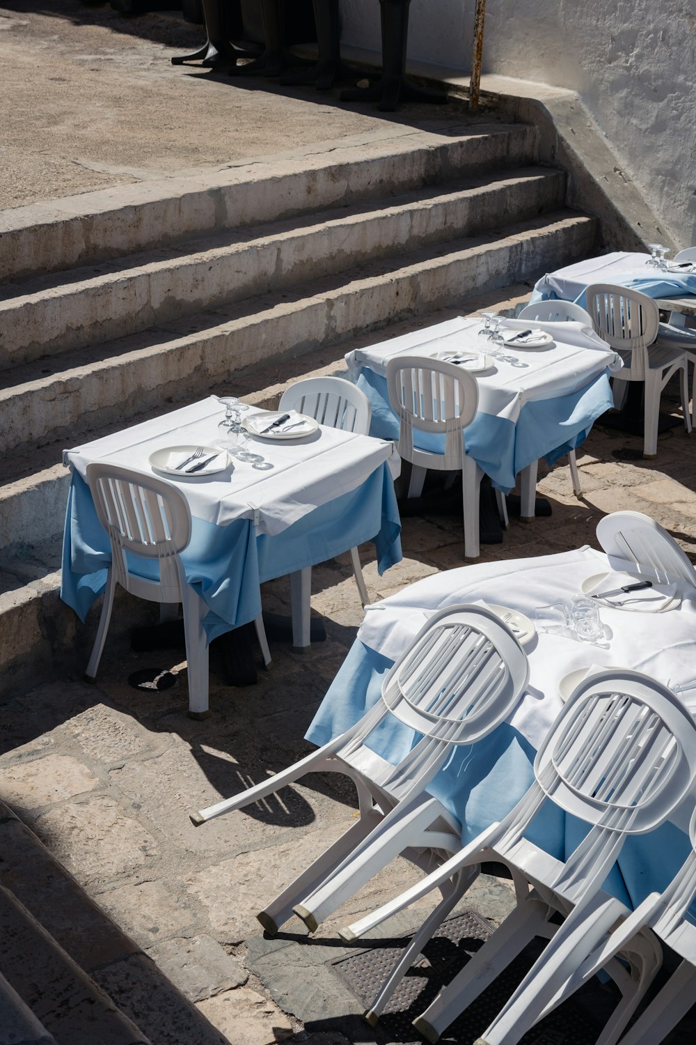 a group of tables and chairs outside