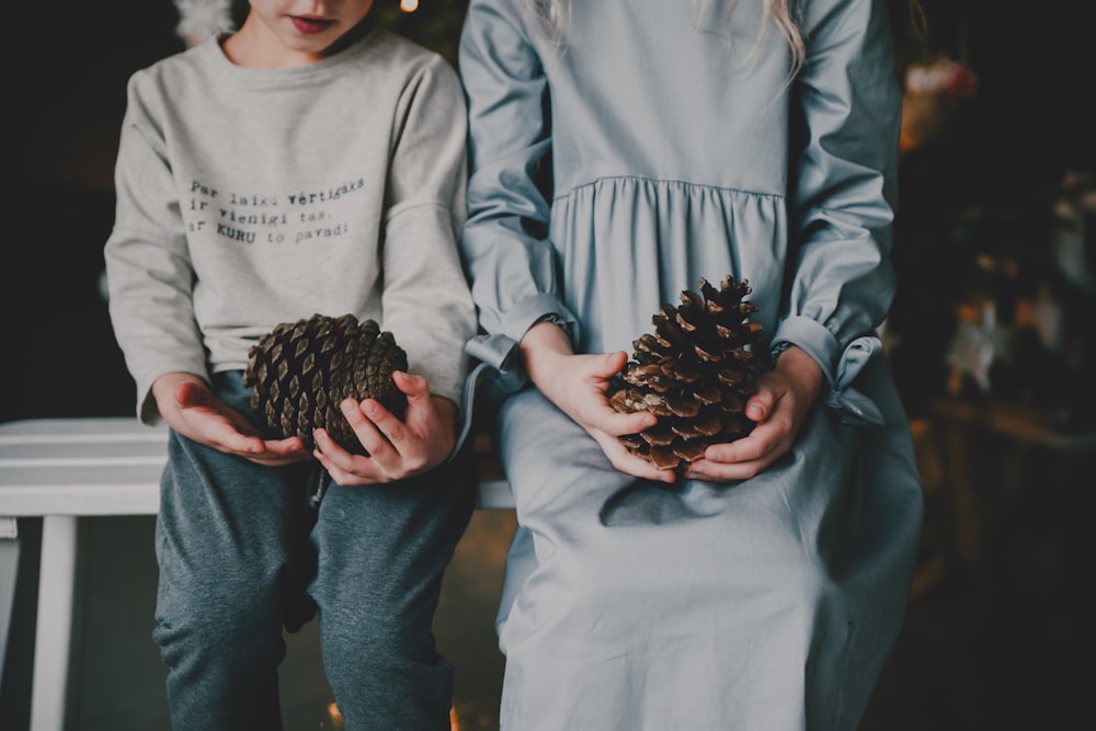 a person holding a pine cone