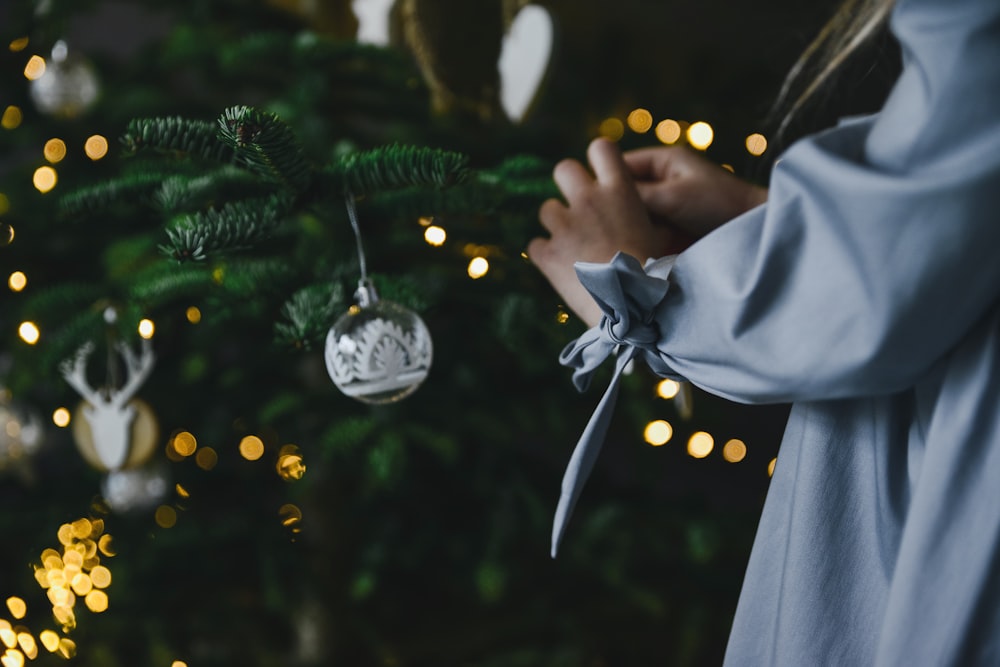 a person holding a christmas tree