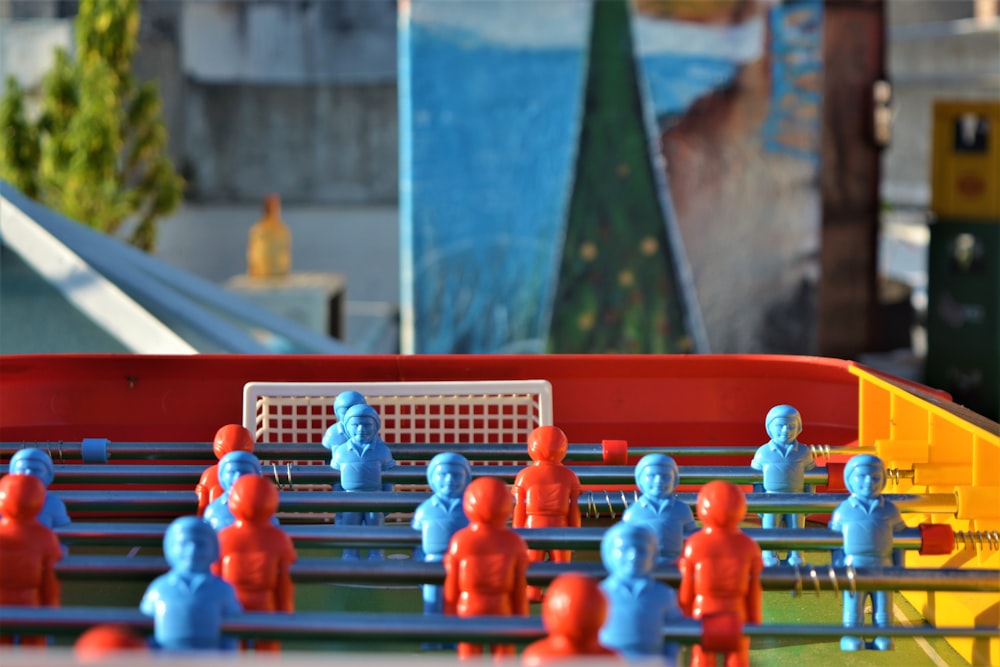 a group of people in blue and red clothing standing on a bridge