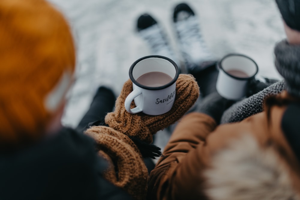 a person holding a coffee cup