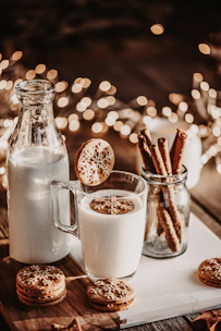 A cozy kitchen scene with fresh milk bottles lined up on a wooden table, sunlight streaming through the window.