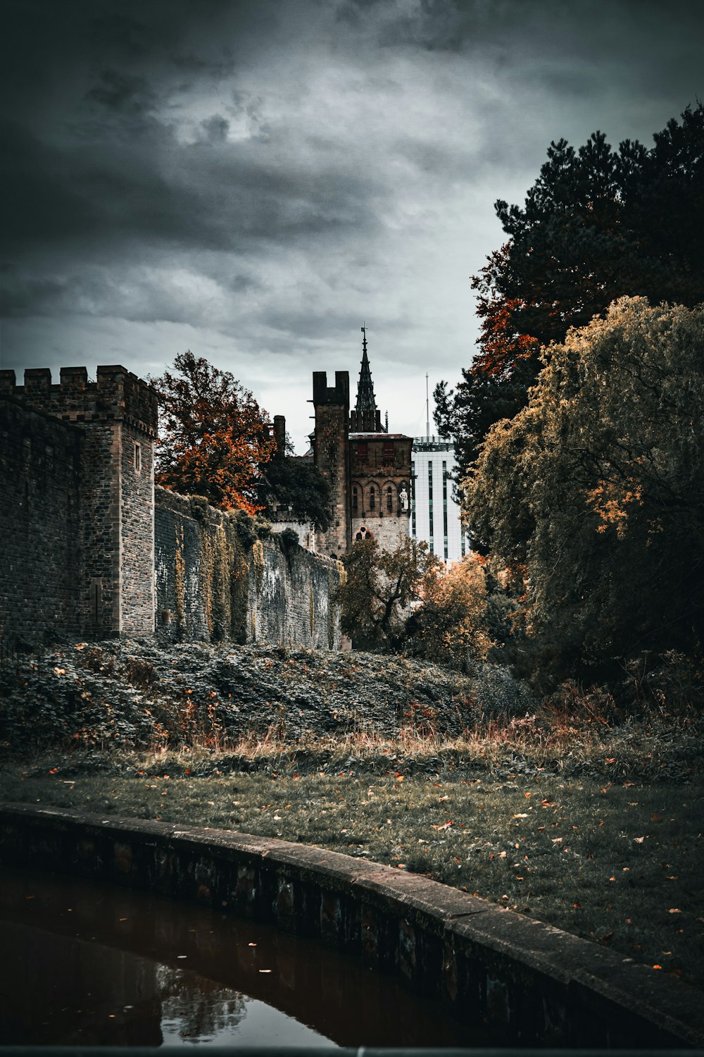 a castle with a moat and trees around it