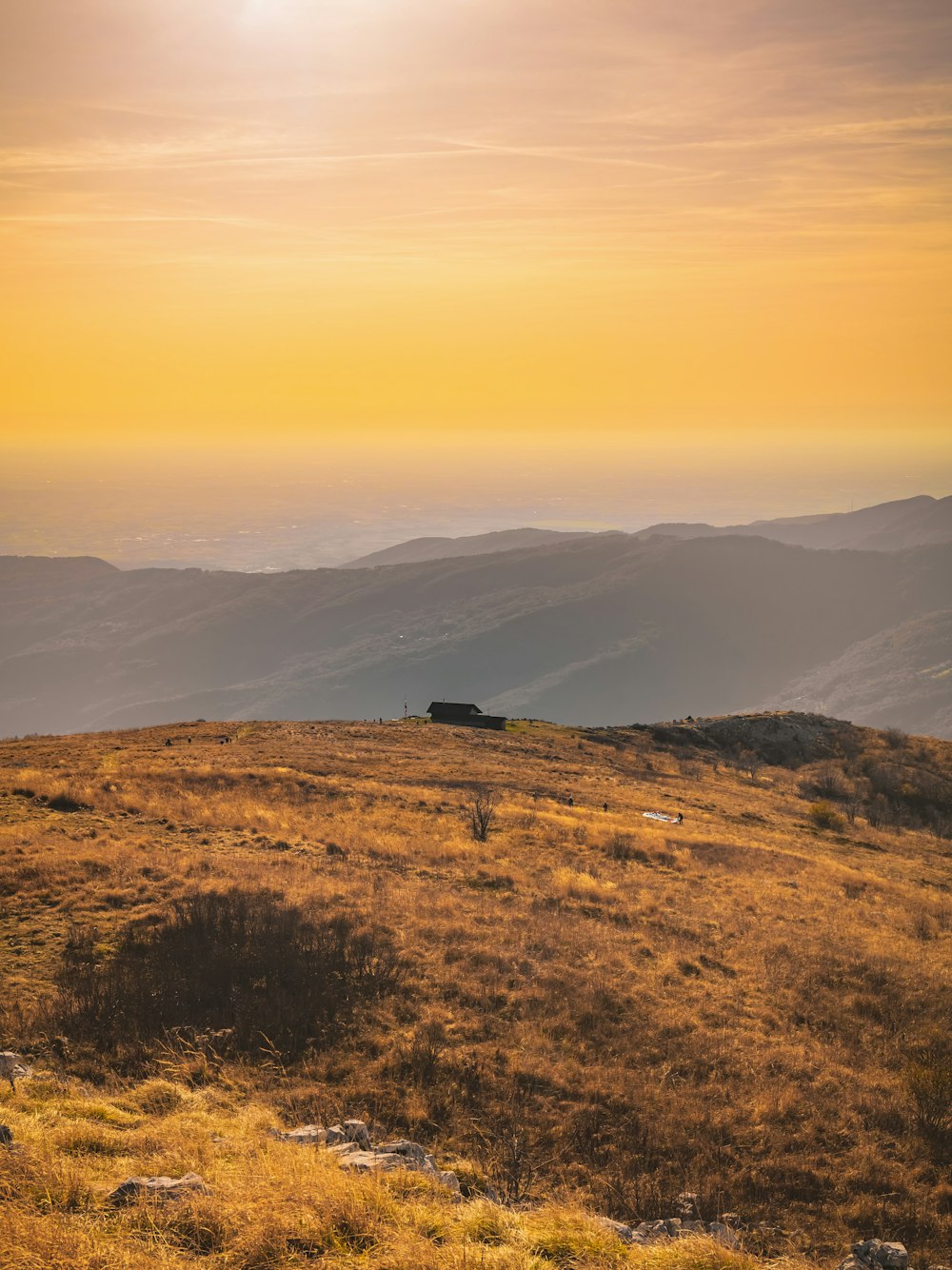 a landscape with hills and a building