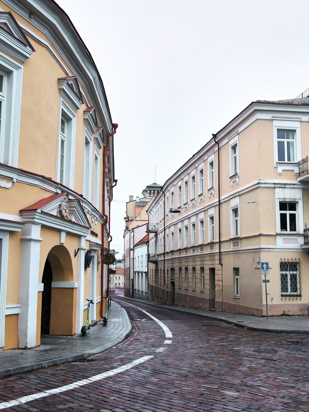 a cobblestone street between buildings