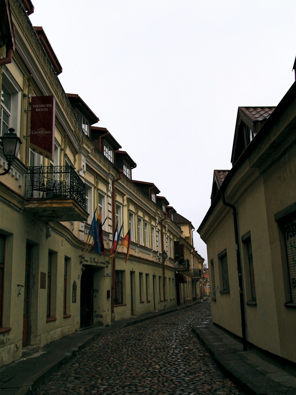 a cobblestone street with buildings on either side of it