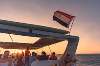 Guests laughing and relaxing on the deck of a boat during a sunset cruise.