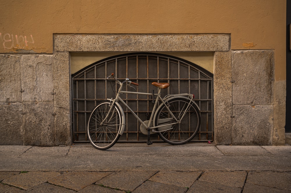 a bicycle parked in front of a gate