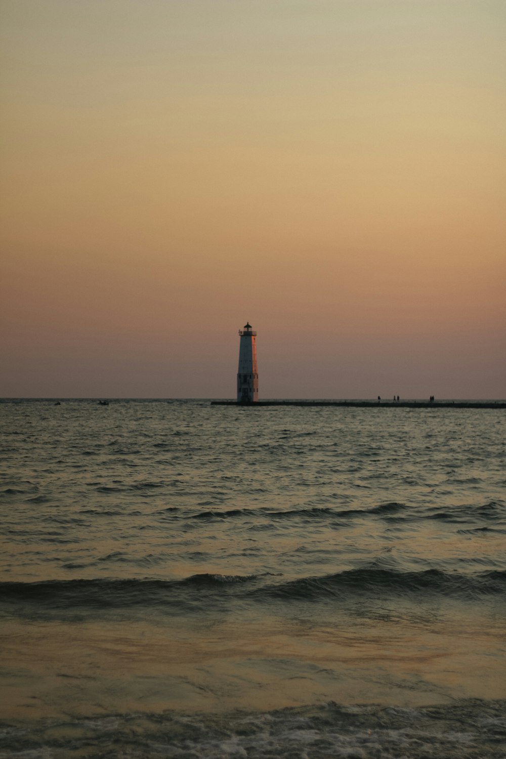 a lighthouse in the middle of the ocean