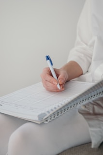 a person writing on a book