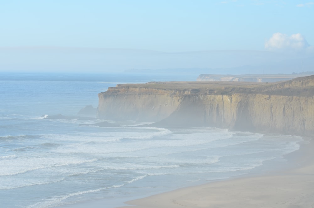 a large cliff next to the ocean