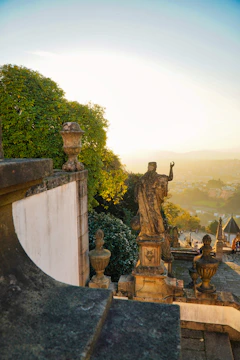 Historic stone staircase surrounded by lush greenery in the Domaine d’Arry park