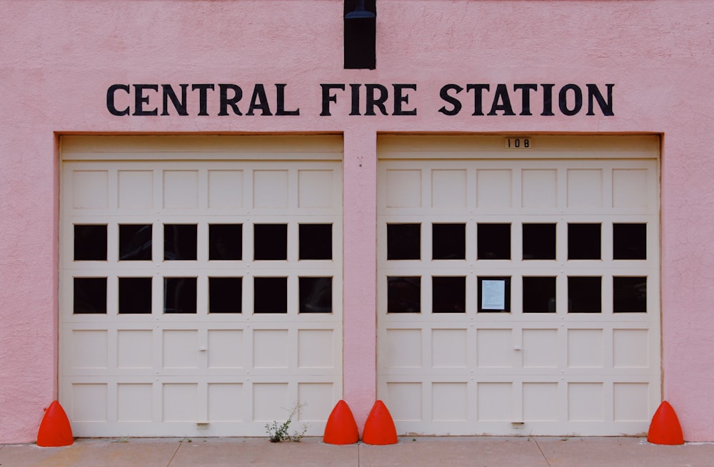 a white garage door with orange cones