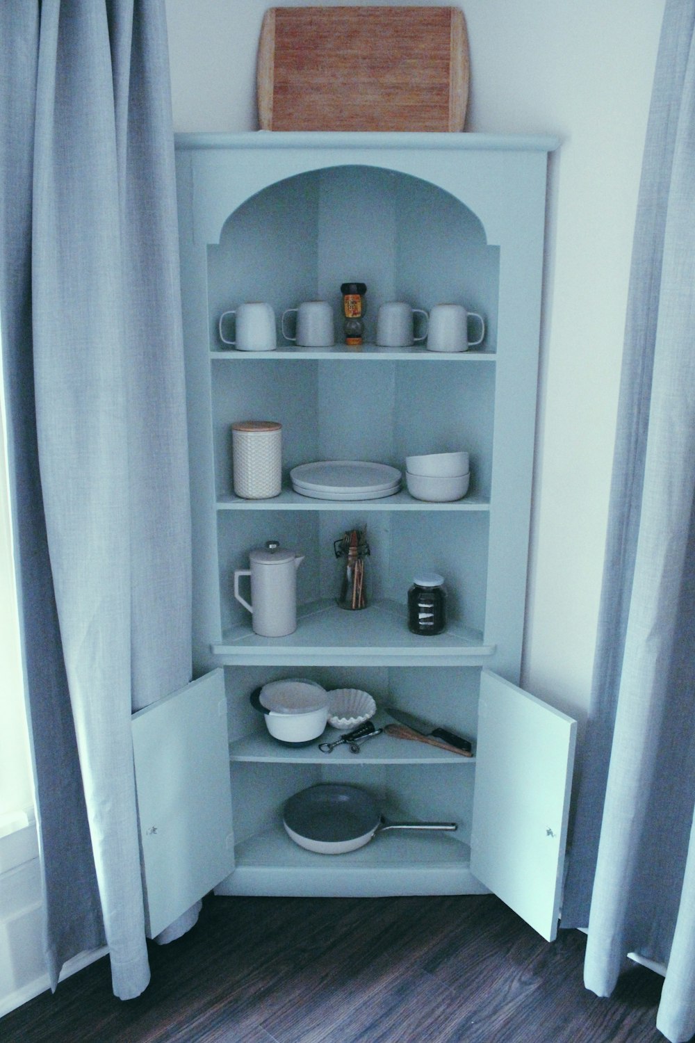 a shelf with dishes and cups on it