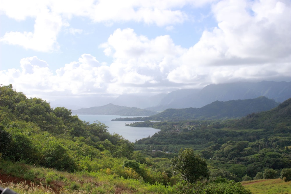 a lake surrounded by trees and hills