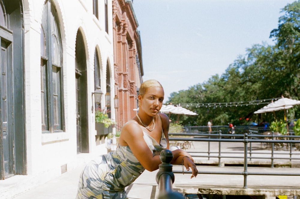 a woman sitting on a railing