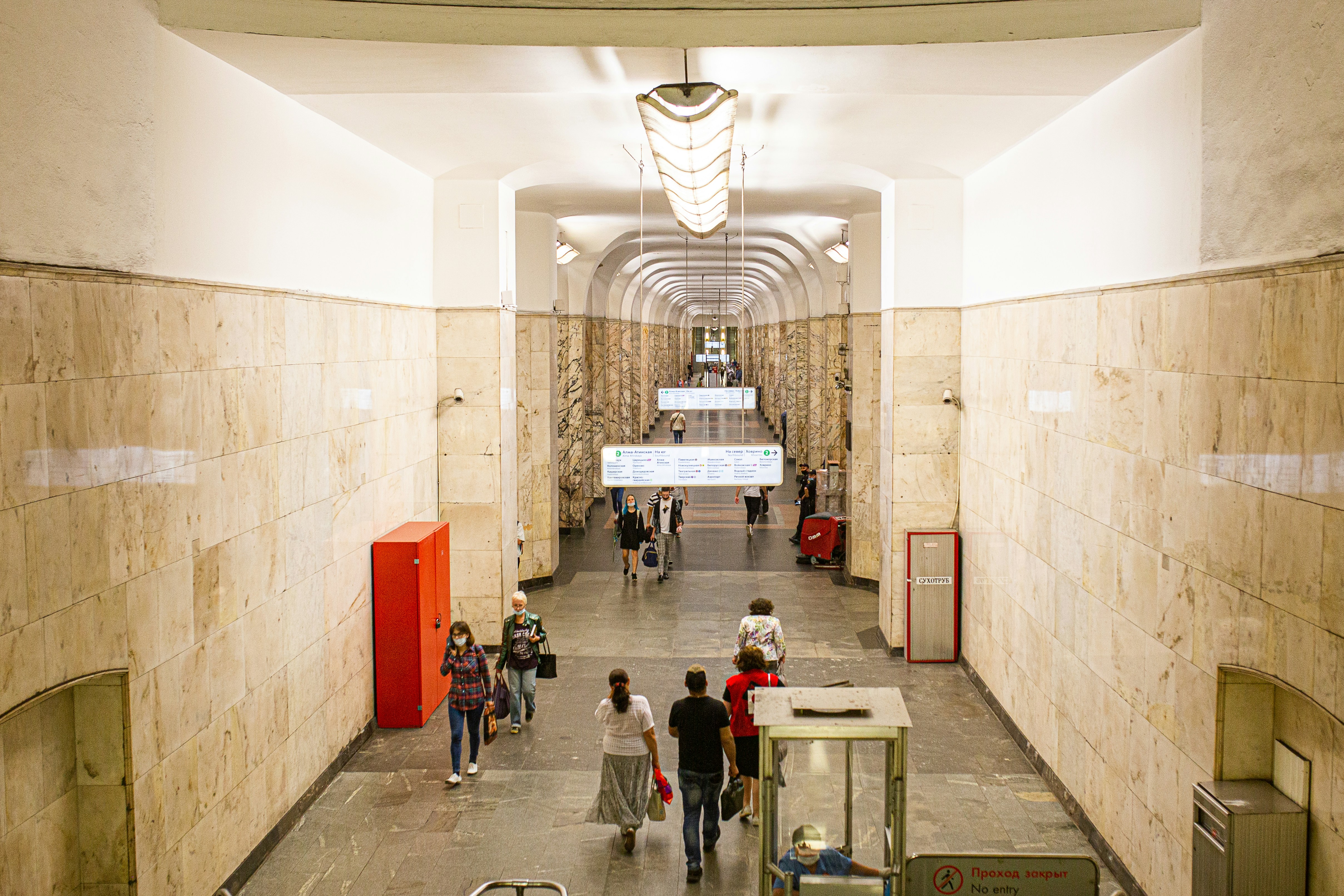 a group of people walking through a building