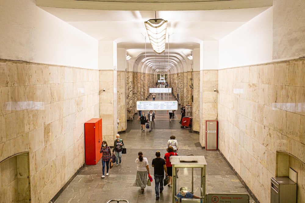 a group of people walking through a building