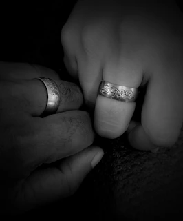 A playful scene of two children exchanging colorful kids’ rings, their hands gently touching.