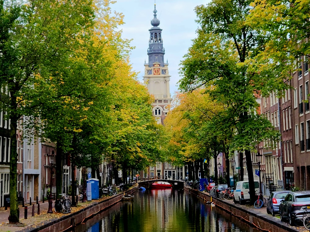 a canal with a tower in the background